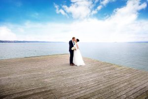 Brautpaar steht auf Floss inmitten des Bodensees