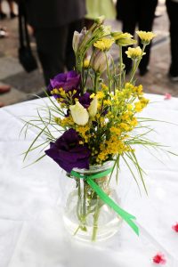 Blumen in Vase mit grünen Band