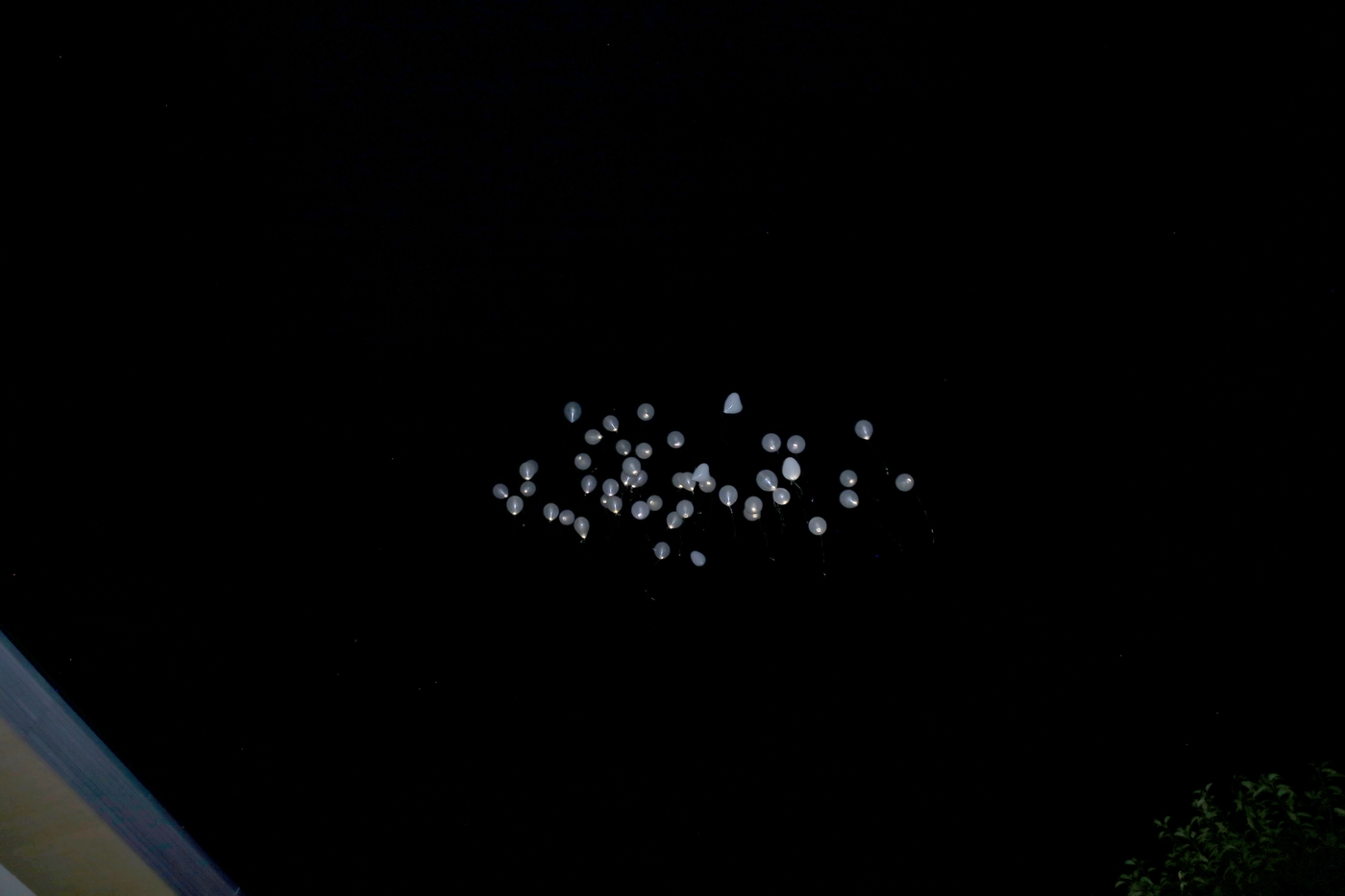 Weiße Ballons bei Nacht in der Luft fliegend